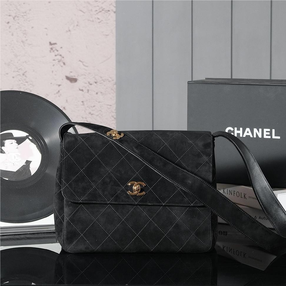 Chanel's iconic Classic Flap bag in black suede and chain Chanel's iconic Classic Flap bag in black suede and chain