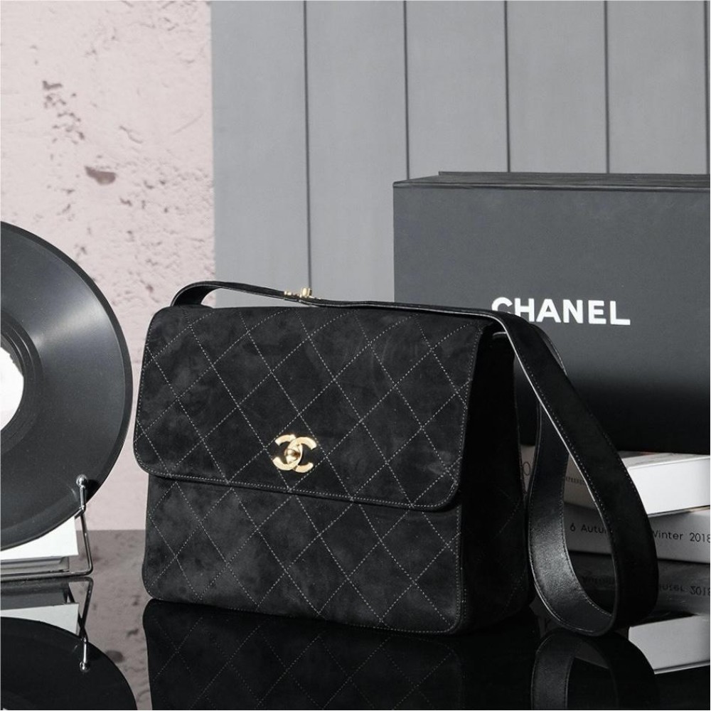 Chanel's iconic Classic Flap bag in black suede and chain Chanel's iconic Classic Flap bag in black suede and chain