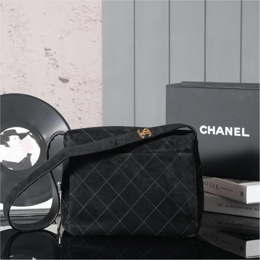 Chanel's iconic Classic Flap bag in black suede and chain Chanel's iconic Classic Flap bag in black suede and chain