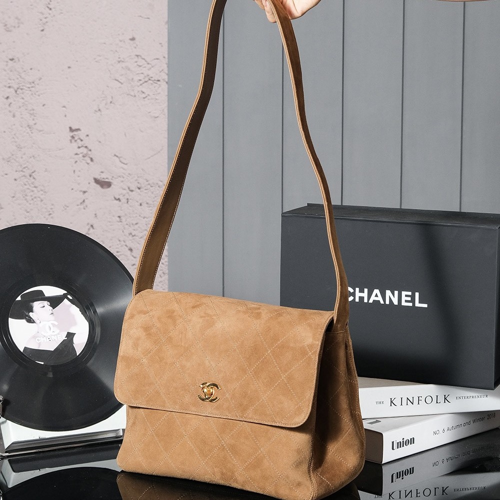 Chanel's iconic Classic Flap bag in brown suede and chain Chanel's iconic Classic Flap bag in brown suede and chain